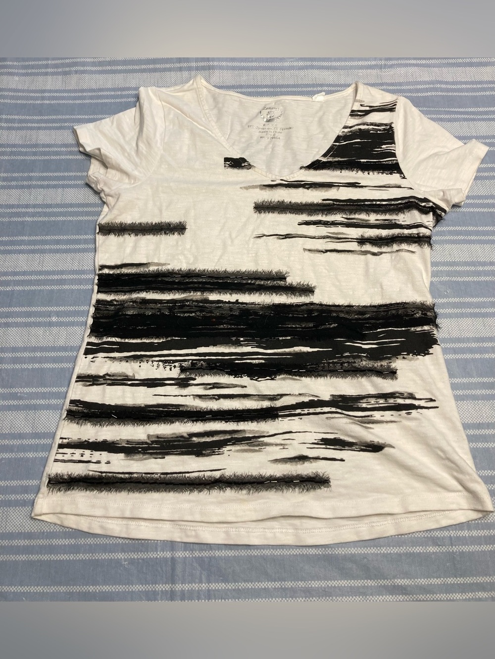 Chico’s Zenery off-white top with black textured designs.